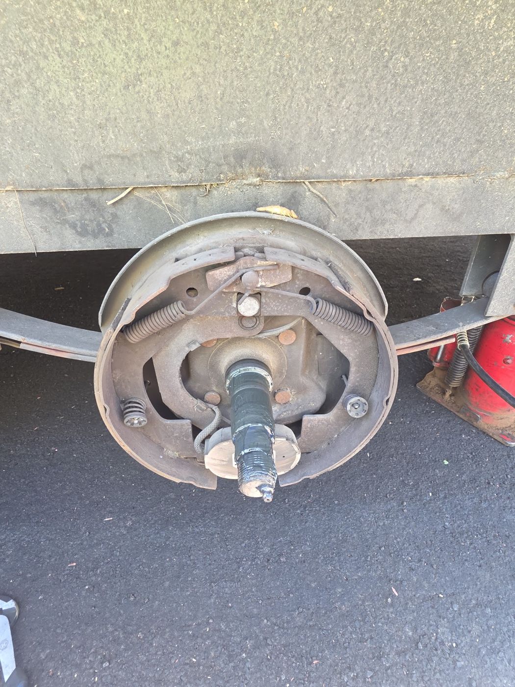 A trailer brake drum with the shoes visible