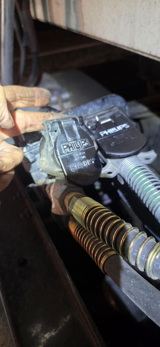 A tire pressure sensor being held in a gloved hand