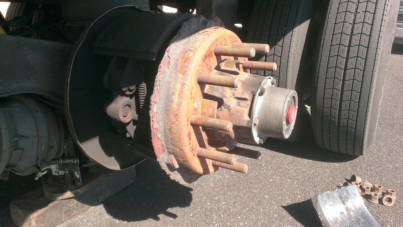 A rusty truck wheel hub with the studs showing